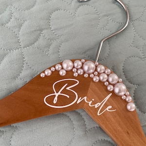 Gorgeous personalised pearl-kissed hangers custom made for you. White or ivory pearls to suit. Bride, Mrs or custom decal or keep blank.