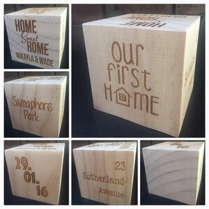May include: A wooden cube with six sides, each side has a different inscription. The inscriptions are: "Home Sweet Home Mikayla & Wade", "Semaphore Park", "Our First Home", "29. 01. 16", "23 Sutherland Avenue", and a blank side.