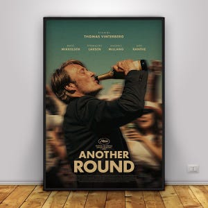 May include: A movie poster for Another Round featuring a man in a dark suit drinking from a bottle. Text includes A FILM BY THOMAS VINTERBERG, the names MADS MIKKELSEN, THOMAS BO LARSEN, MAGNUS MILLANG, LARS RANTHE, and the title ANOTHER ROUND.
