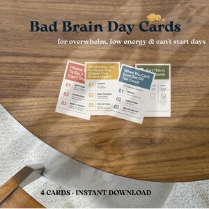 May include: A set of four rectangular cards titled Bad Brain Day Cards for overwhelm, low energy & can't-start days. The cards are red, yellow, blue, and green, each featuring numbered lists and instructional text for daily routines.