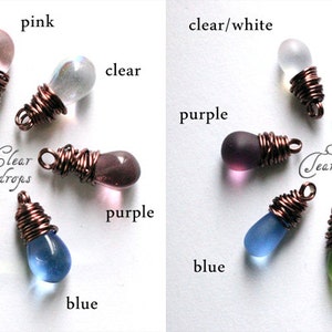 May include: Assortment of glass teardrop beads wrapped in copper wire. The beads are in various colors, including red, pink, clear, amber, green, blue, and purple. The text "Clear Teardrops" and "Satin Teardrops" is visible on the image.