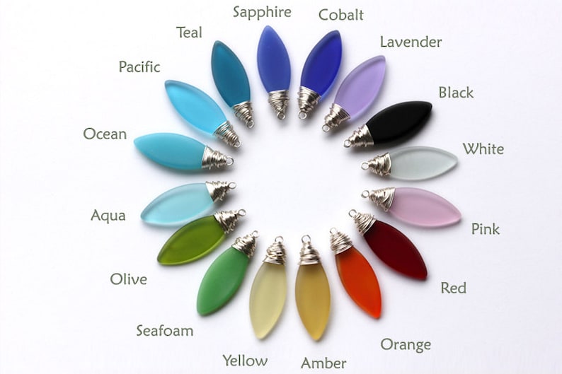 May include: A selection of 16 glass pendants in various colors, including teal, sapphire, cobalt, lavender, black, white, pink, red, orange, yellow, amber, seafoam, olive, aqua, ocean, and pacific. Each pendant is shaped like a teardrop and has a silver wire wrapped around the top.