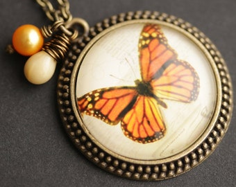 Monarch Butterfly Necklace. Orange Butterfly Pendant. Butterfly Picture Necklace with Cream Teardrop and Orange Fresh Water Pearl Charm.