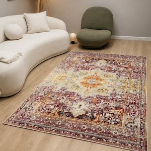 May include: A rectangular area rug featuring a distressed pattern with a central medallion in shades of deep burgundy, burnt orange, cream, and muted gold. The design includes intricate border details and a faded, vintage-inspired color palette.