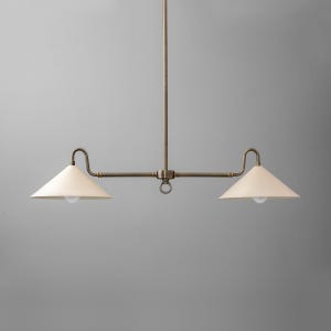 May include: A brass two-light pendant light fixture with two white conical shades.