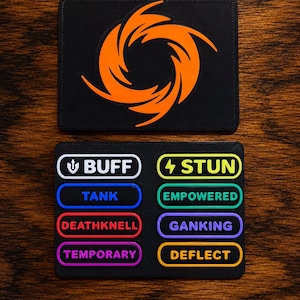 May include: A black rectangular patch featuring an orange swirling graphic, and a second black rectangular patch with eight colorful labels: BUFF, STUN, TANK, EMPOWERED, DEATHKNELL, GANKING, TEMPORARY, and DEFLECT, each with a distinct border color.