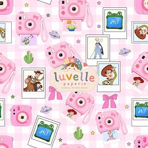 May include: A seamless pattern design featuring pink instant cameras, polaroid-style photos of cartoon characters, green cacti, purple planets, and pink bows on a light pink checkered background. The center text reads luvelle paperie.