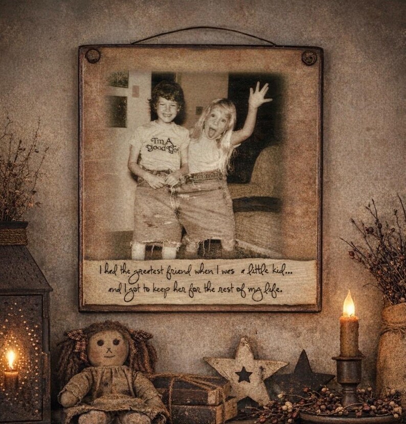 May include: A framed photograph featuring two children, one wearing a shirt that says "I'm a Good Girl". The frame has a quote: "I had the greatest friend when I was a little kid... and I got to keep her for the rest of my life."