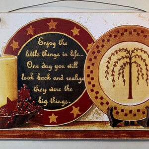 May include: Rectangular wooden sign with a rustic design. The sign features two decorative plates, a candle, and a bowl of berries. Text on the sign reads, "Enjoy the little things in life... One day you will look back and realize they were the big things."