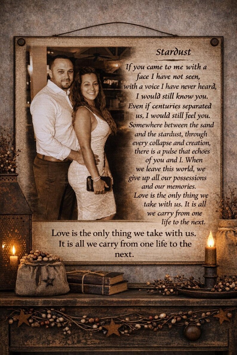 May include: A framed print featuring a couple, with the text "Stardust" and a romantic poem. The image has a warm, sepia tone, with candles and rustic decor.