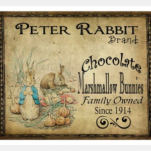 May include: Vintage-style label with the text "Peter Rabbit Brand Chocolate Marshmallow Bunnies Family Owned Since 1914". The label features an illustration of two rabbits in a garden setting.