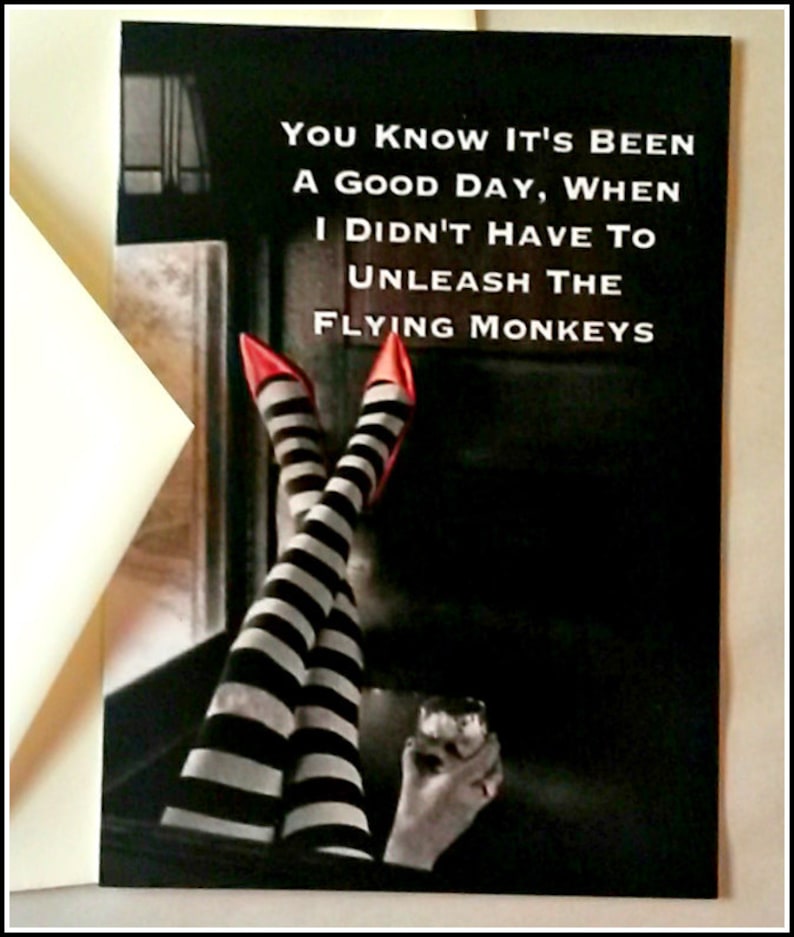 May include: A black and white illustration of a woman's legs wearing red shoes and black and white striped stockings. The text "YOU KNOW IT'S BEEN A GOOD DAY, WHEN I DIDN'T HAVE TO UNLEASH THE FLYING MONKEYS" is written in white on a black background.
