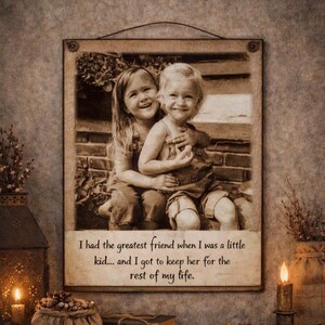 May include: Sepia-toned framed print featuring two smiling children embracing. The print includes the text: "I had the greatest friend when I was a little kid... and I got to keep her for the rest of my life."