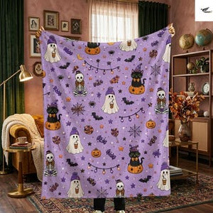 May include: A light purple fleece blanket featuring a repeating Halloween pattern of white ghosts wearing purple hats, black cats sitting on orange pumpkins, skeletons, spider webs, bats, orange pumpkins, and colorful candies on a string.
