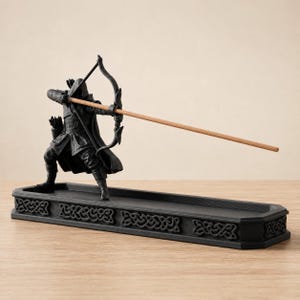 Unlit black fantasy archer incense holder with bow, quiver, incense-stick arrow, and long Celtic-style ash tray