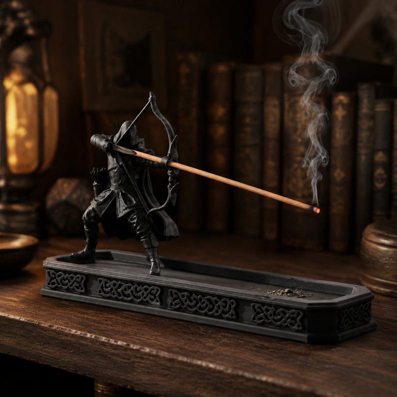Hooded archer incense burner displayed in a dark fantasy reading nook with smoke rising from the incense arrow