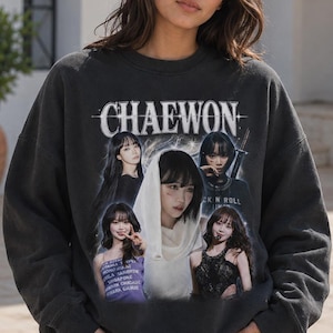 May include: A charcoal grey crewneck sweatshirt featuring a graphic print with the text CHAEWON at the top. The design includes multiple photographic portraits of a person in various outfits and poses, arranged in a collage style on the front.