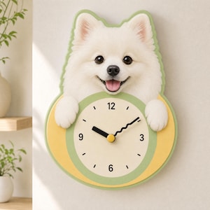May include: A wall clock shaped like a white Pomeranian dog with its paws resting on a circular clock face. The clock features a cream-colored dial with black numerals at 3, 6, 9, and 12, black hour and minute hands, and a green and yellow border.