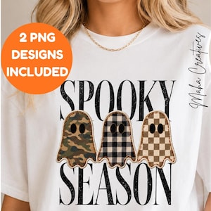 May include: A white t-shirt featuring the text SPOOKY SEASON in black distressed lettering. Between the words are three ghost illustrations with different patterns: one in green camouflage, one in black and white plaid, and one in a tan checkerboard.