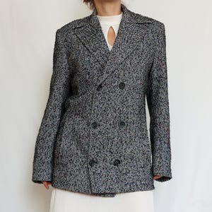 May include: A black and white herringbone patterned double-breasted blazer with black buttons.