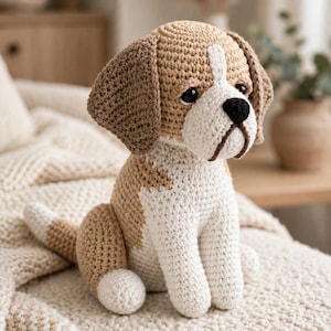 May include: A crocheted beagle dog toy featuring a tan and white yarn body, dark brown floppy ears, black plastic eyes, and a black stitched nose. The stuffed animal is sitting in an upright position with a white chest and a tan patch on its back.