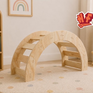 May include: A light-colored wooden climbing arch featuring a series of horizontal rungs connecting two arched side panels. The structure is constructed from plywood with visible wood grain and small rectangular joinery details along the frame.