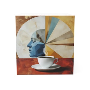 May include: A white ceramic coffee cup and saucer sit before a rectangular wall art piece. The artwork features a stylized blue geometric human profile on the left and a radiating sunburst pattern in shades of gold, blue, and white on the right.