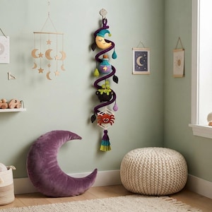 May include: A vertical crochet wall hanging featuring a dark purple spiral vine adorned with a yellow crescent moon, a blue potion bottle, a black cauldron with green bubbles, and a red spider on a white web, finished with a multi-colored tassel.