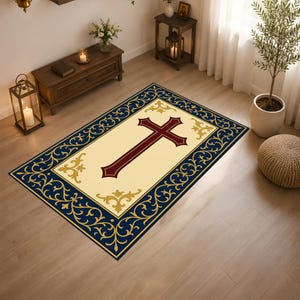 Puede incluir: Una alfombra rectangular con un centro de color crema y una cruz de color rojo oscuro. La alfombra está enmarcada por un borde ancho de color azul marino decorado con intrincados patrones florales dorados y detalles en oro.