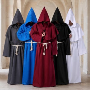 May include: Five hooded robes in dark gray, blue, maroon, black, and white. Each robe features a pointed hood, long sleeves, a shoulder capelet, and a white rope belt tied at the waist. The garments are floor-length and have a loose fit.