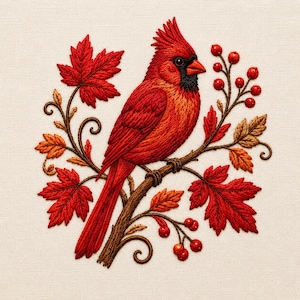 May include: A detailed embroidery piece featuring a vibrant red cardinal bird perched on a brown branch. The bird is surrounded by bright red maple leaves and small clusters of red berries, all rendered with intricate stitching on a cream fabric.