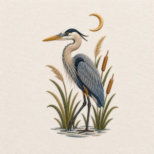May include: An embroidery design featuring a blue heron standing among tall grasses and cattails. The bird has a long yellow beak, a grey and white neck, and blue-grey wings. A golden crescent moon is stitched above the bird on a cream fabric.