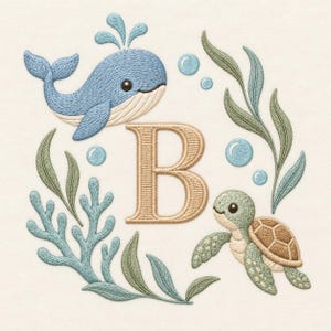 May include: An embroidery design featuring a large tan letter B centered among aquatic elements. A blue whale, a green sea turtle, light blue bubbles, and green seaweed are arranged around the letter on a plain off-white fabric background.