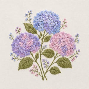 May include: An embroidery design featuring three large hydrangea clusters in shades of blue, lavender, and pink, accented with small buds and detailed green leaves. The floral arrangement is stitched onto a plain, light-colored fabric background.