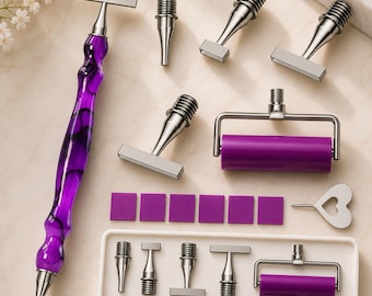 May include: A set of crafting tools including a long purple marbled handle with a metal tip, several interchangeable metal stamp heads, a purple roller, six small purple square pads, a heart-shaped metal tool, and a white storage tray.