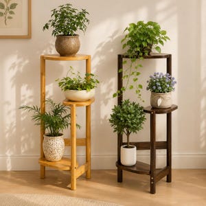 May include: Two tiered plant stands made of wood, one in a light natural finish and one in a dark brown finish. Each stand features three circular shelves at varying heights, holding a variety of potted green plants and small flowering plants.