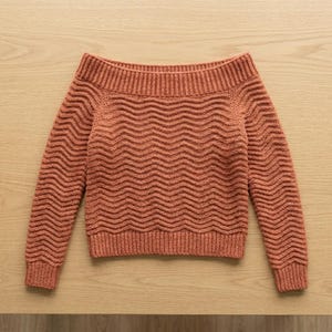 May include: A terracotta-colored off-the-shoulder sweater featuring a horizontal wavy knit pattern throughout the body and sleeves. The garment includes a wide ribbed neckline, ribbed cuffs, and a ribbed hem, all crafted in a consistent knit texture.
