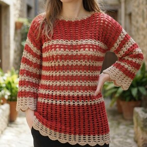 May include: A long-sleeved crochet sweater featuring horizontal stripes in alternating shades of deep red and beige. The garment has a round neckline, a semi-sheer openwork stitch pattern throughout, and scalloped edges along the cuffs and hemline.
