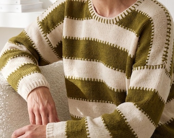 May include: A long-sleeved knit sweater featuring horizontal stripes in olive green and cream. The garment has a round neckline and a visible stitch detail along the seams where the stripes meet, creating a textured look across the torso and sleeves.