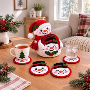 May include: A set of crocheted snowman coasters stored in a matching snowman-shaped basket. The coasters are round with white faces, orange carrot noses, pink cheeks, and black top hats. The basket features a red hat and scarf with white trim.