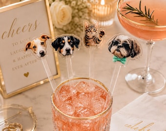 May include: Four clear acrylic drink stirrers featuring custom printed animal portraits. The stirrers display a brown and white dog, a black and tan dog, a tabby cat, and a shaggy dog wearing black sunglasses and a light green bow tie.