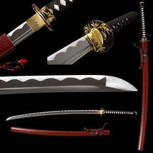 May include: A katana sword featuring a curved steel blade with a wavy hamon line, a black wrapped handle, and a gold-toned tsuba guard decorated with bamboo motifs. The sword includes a red scabbard with a black and red cord wrap detail.