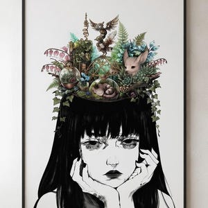 May include: A framed art print featuring a black and white illustration of a person with long black hair. The top of the head is open, revealing a colorful collection of terrariums, ferns, succulents, a small fox-like creature, and an owl.