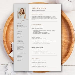 May include: A professional CV template featuring a light grey sidebar with a headshot of a woman, contact details, expertise, software knowledge, and personal skills. The main section includes sections for personal profile, work experience, and education.