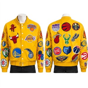 May include: A bright yellow varsity jacket featuring a snap-button front closure and ribbed collar, cuffs, and hem. The jacket is covered in various embroidered patches representing multiple professional basketball team logos and team-related graphics.
