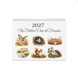 May include: A 2027 wall calendar titled The Fallow Deer & Friends. The cover features six watercolor illustrations of woodland animals including an owl, a badger, a fox, a fallow deer drinking from a stream, a squirrel, and a hedgehog.