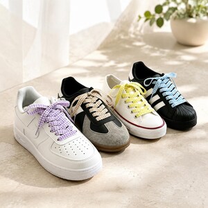 May include: Four sneakers arranged in a row. The first is white with purple gingham laces. The second is black and grey with beige gingham laces. The third is white with yellow gingham laces. The fourth is black with white stripes and blue gingham laces.