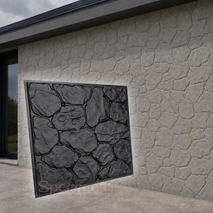 Pode incluir: Um molde quadrado de borracha preta com um padrão de pedra irregular em relevo. O molde está posicionado em frente a uma parede cinza-clara com textura de pedra correspondente. O texto "Specmolds" é visível em fonte clara na base.