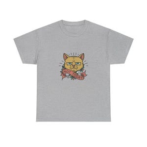 May include: A heather gray short-sleeve t-shirt featuring a central graphic of a grumpy yellow cat with green eyes. Below the cat is a red ribbon banner with the text NOT TODAY in black capital letters, surrounded by small green leaves.