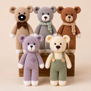 May include: Five handmade crochet teddy bears in various colours. The top row features a tan bear with a brown bow tie, a grey bear with a light green scarf, and a brown bear with a tan scarf. The bottom row has a lavender bear with a heart and a cream bear wearing green overalls.
